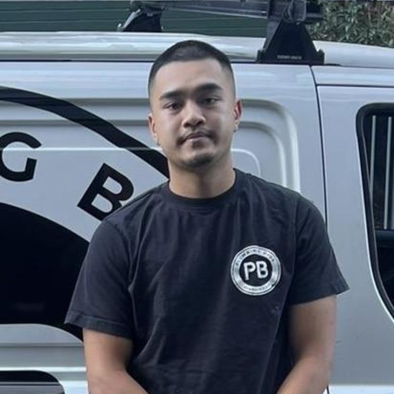 Harry, a friendly plumber from Plumbing Bros Chatswood, standing in front of a Plumbing Bros van.